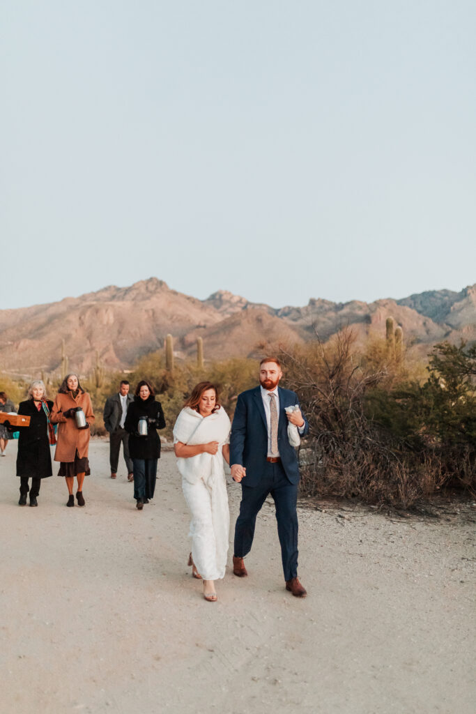 Couple walking hand-in-hand through the canyon before the ceremony.