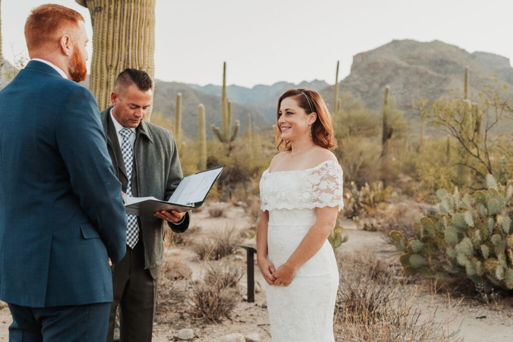Couple exchanging vows under crested saguaro Sabino Canyon sunrise elopement