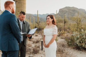 Bride and groom smiling as they complete their sunrise vows.