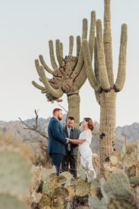 Emotional moment captured between couple during desert ceremony.