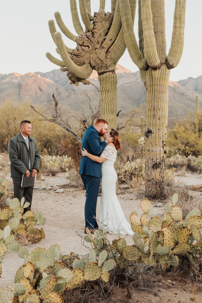 First Kiss tucson wedding under towering cactus at Sabino Canyon sunrise