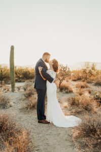 Bride and groom bridal portrait kissing at sunrise at sabino canyon national park tucson arizona