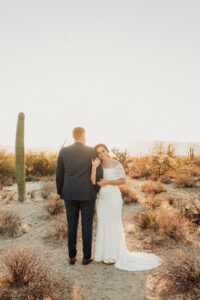bride smiling at camera during sunrise bridal session in the desert