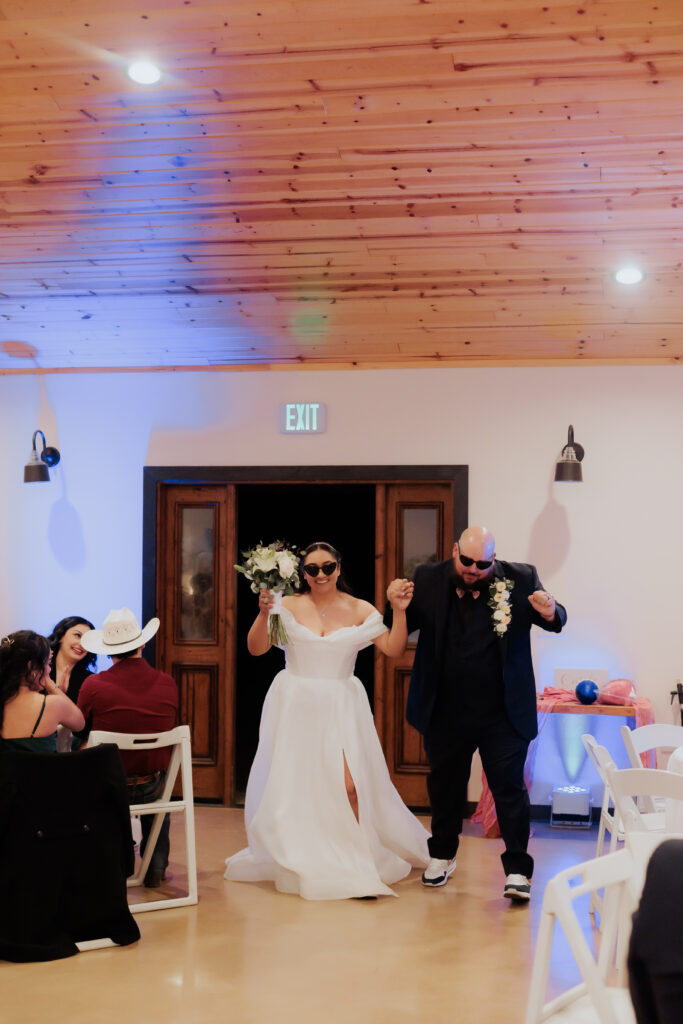 bride and groom walking into reception for grand entrance at rhino ridge