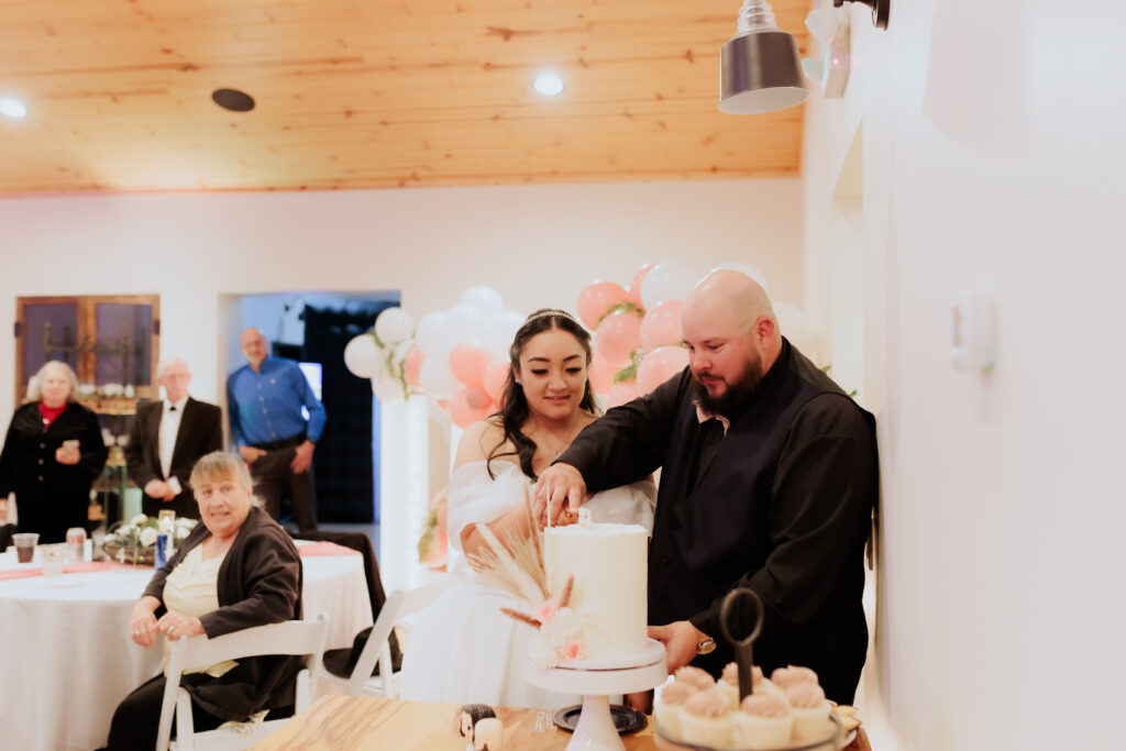 bride and groom cutting cake at wedding reception in willcox arizona