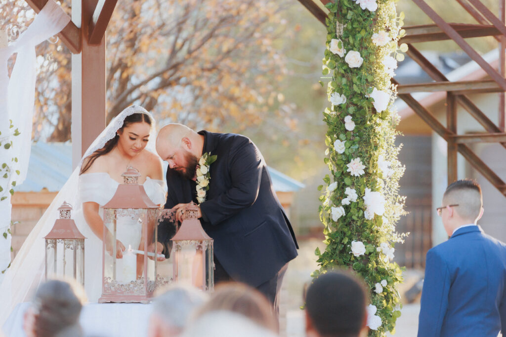 bride and groom lighting candle during ceremony in willcox wedding