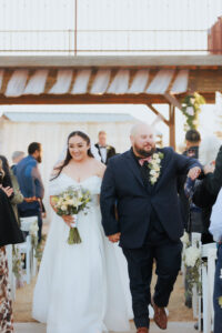 BRIDE AND GROOM WALKING DOWN AISLE AFTER CEREMONY