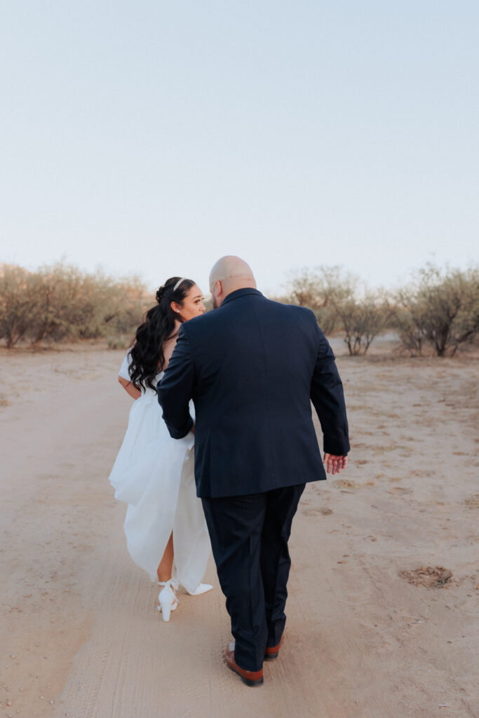 bride and groom walking to take bridal photos at 
