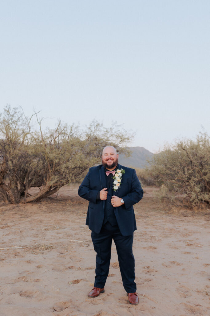 groom posing for portrait after wedding at rhino ridge