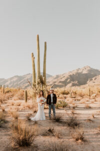 Bride and groom smiling together in the desert