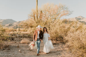Bride and groom walking together along a trail in Sabino Canyon.