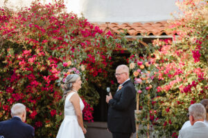 groom saying vows to bride laughing during ceremony
