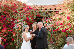 bride putting ring on groom during ceremony