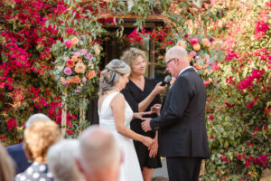 groom putting ring on bride during ceremony