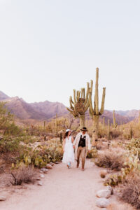 bride and groom walking in desert after ceremony in the arizona desert