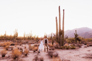 bride and groom holding hands posing in desert for bridal session at sabino canyon