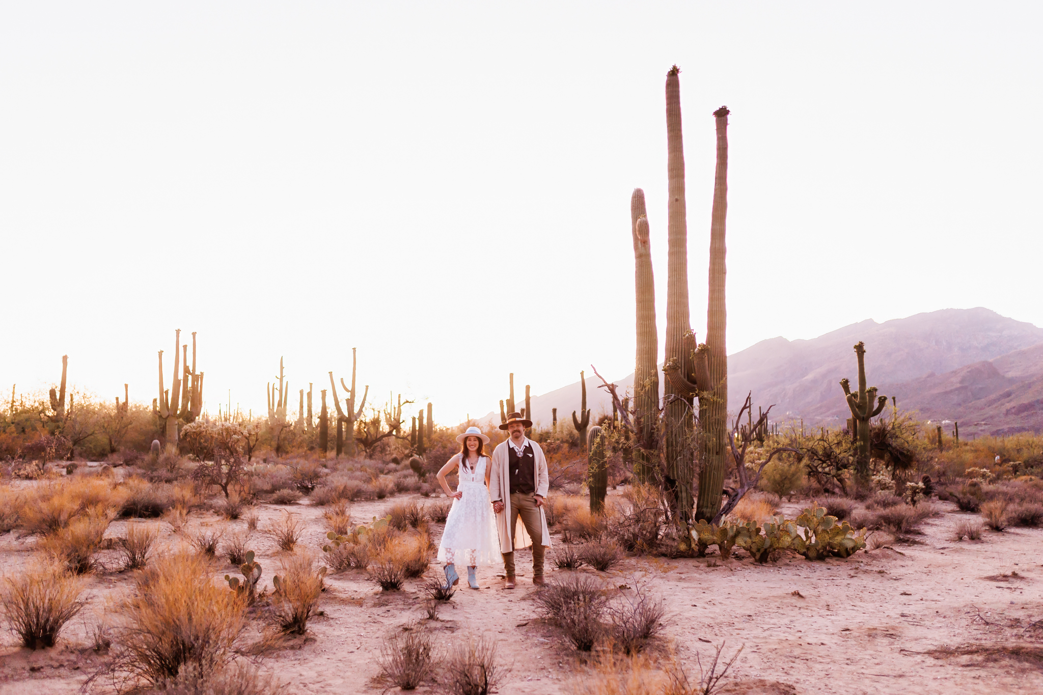 bride and groom holding hands posing in desert for bridal session at sabino canyon